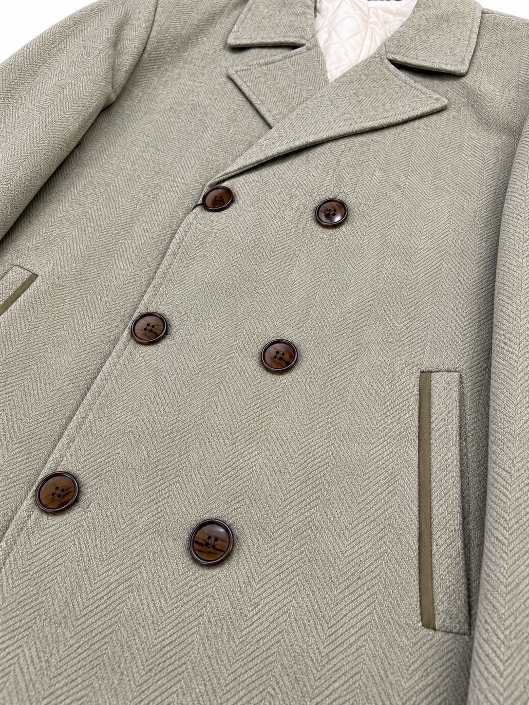 Taupe beige herringbone overcoat fabric and button detail